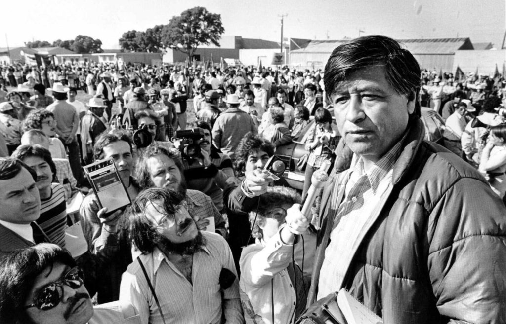 Cesar Chavez standing in front of a crowd of supporters